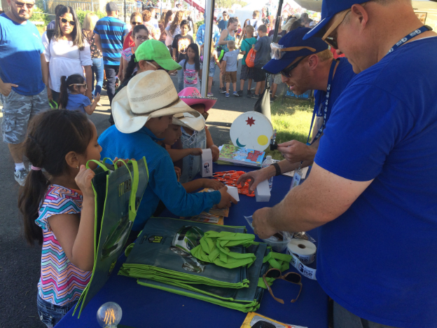 Grant PUD employee giving out freebies at the fair booth